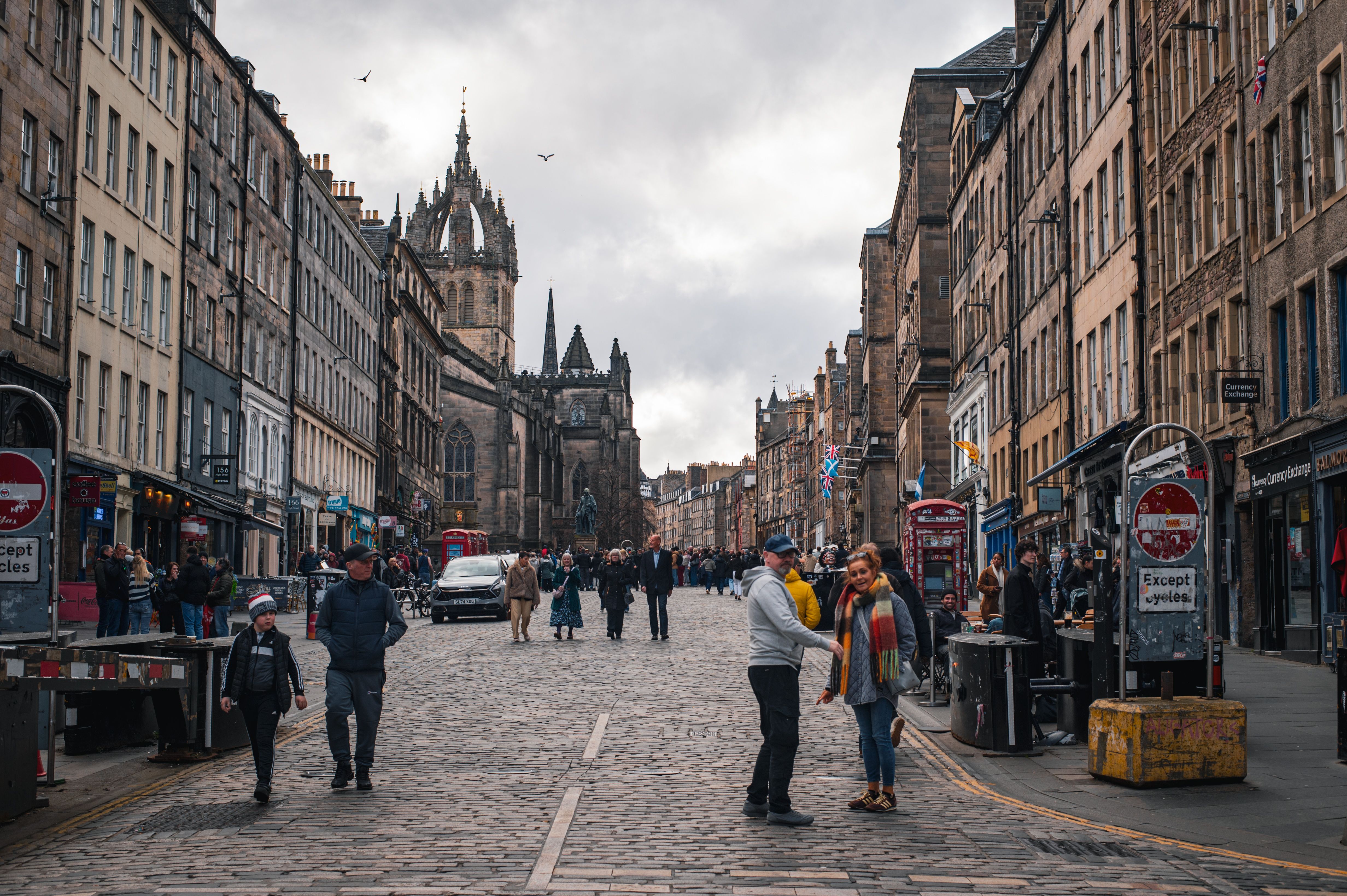 A lively day on the Royal Mile in Edinburgh showing historic architecture and city life