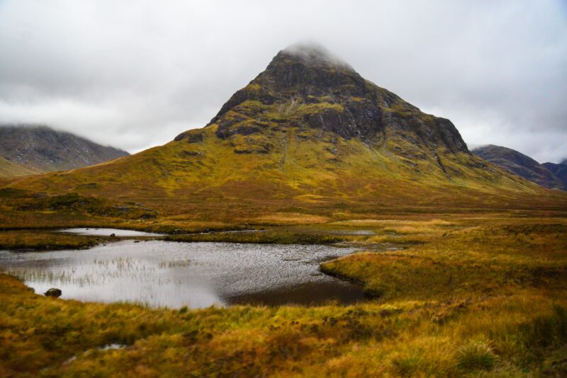 Breathtaking view of a mountain landscape in Glen Coe, Scotland during an autumn day